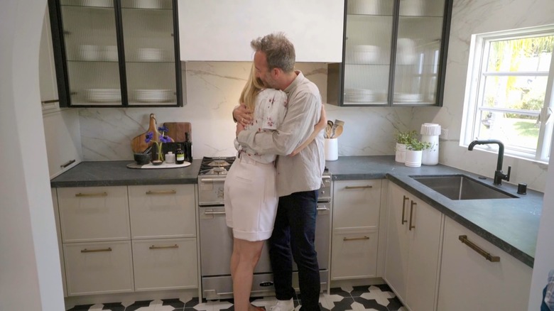 Gwyneth Paltrow and Kevin Keating hugging in his renovated kitchen