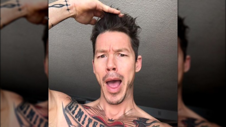 David Bromstad mouth open, holding hair