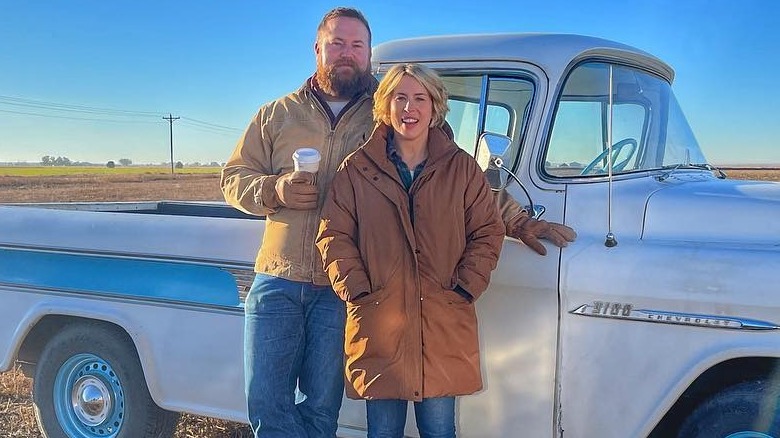 Erin and Ben stand outside in front of a truck 