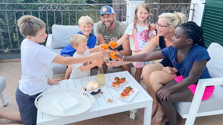 Jenny and Dave Marrs and their kids clinking glasses in a toast