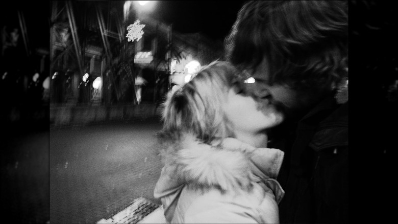 Erin and Ben Napier sharing a blurry kiss in an old photo