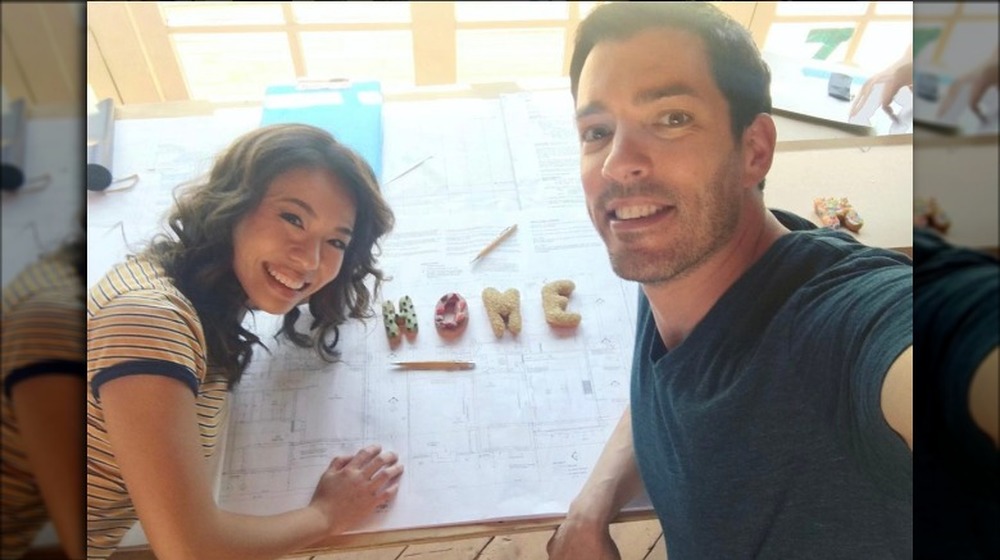 Drew Scott and his wife working