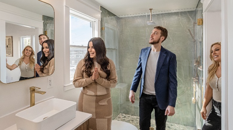 Cristy Lee showing clients a bathroom