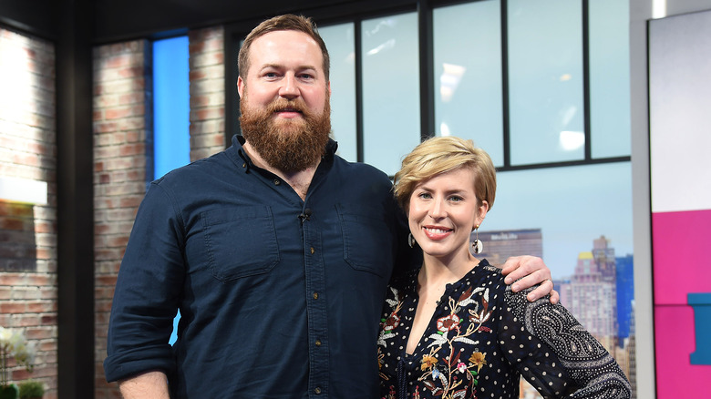 Erin and Ben Napier pose together on stage