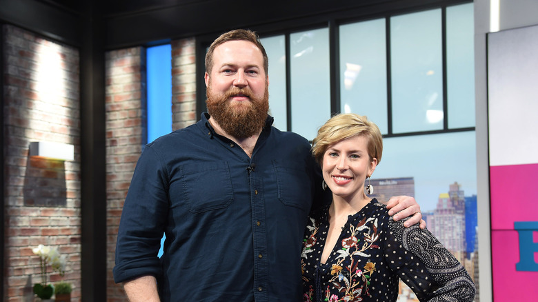 Ben and Erin Napier stand arm in arm