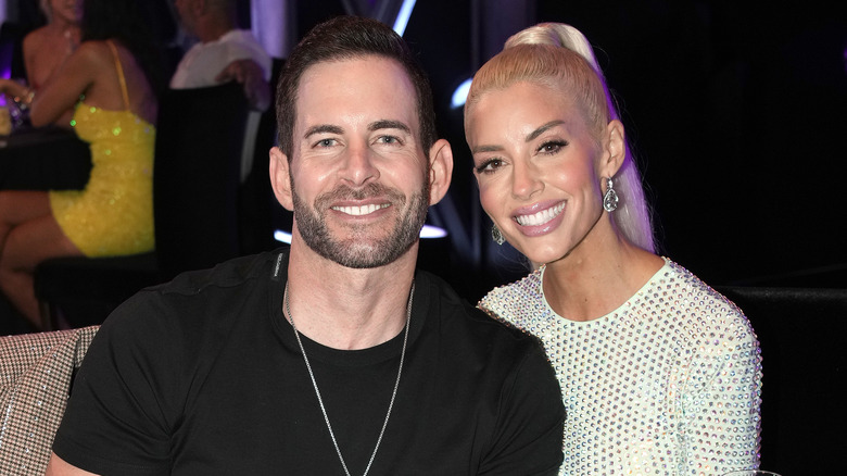 Tarek El Moussa and Heather Rae Young pose together at an event