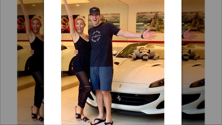 Heather Rae Young and Tarek El Moussa smiling with Ferrari