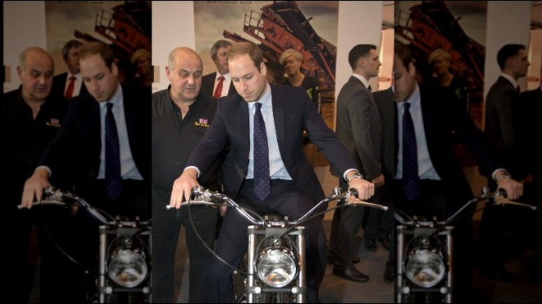 Prince William sitting on a motorcycle