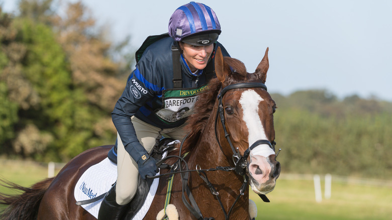 Zara Tindall smiling and riding a horse