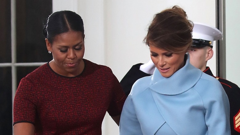 Michelle Obama Melania Trump looking down