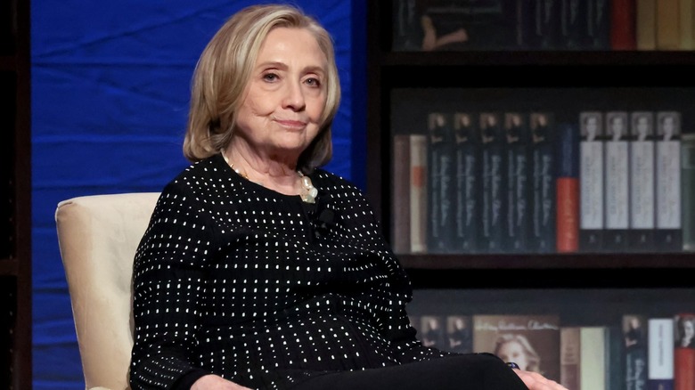 Hillary Clinton sits onstage for her 2024 book release of "Something Lost, Something Gained"