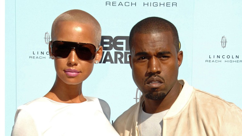 Amber Rose and Kanye West posing 