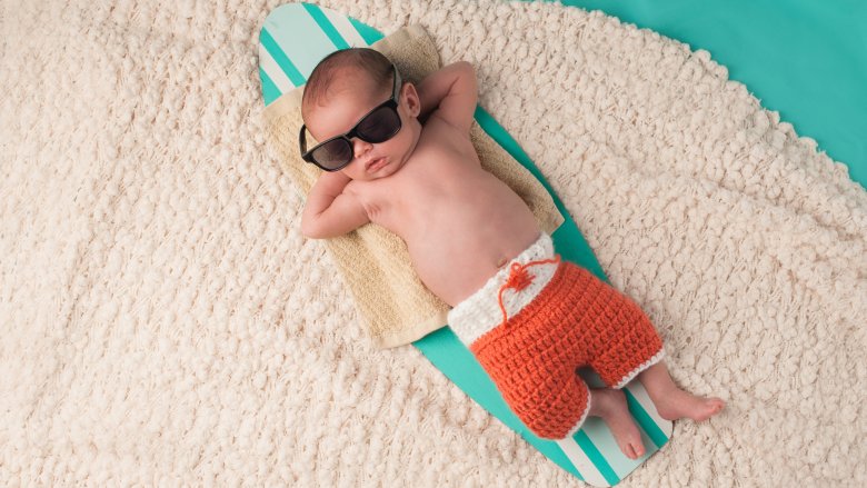 baby with sunglasses in beach scene