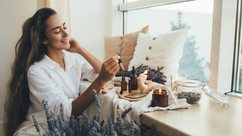 Woman applying essential oils 