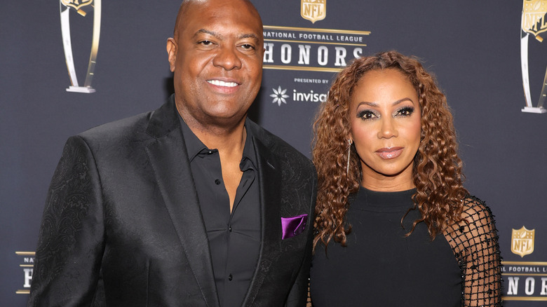 Holly Robinson Peete and Rodney Peete posing at event