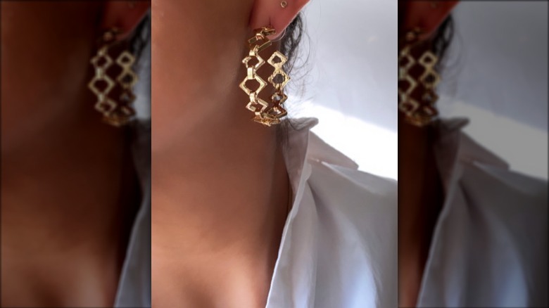 Woman with gold geometric hoops