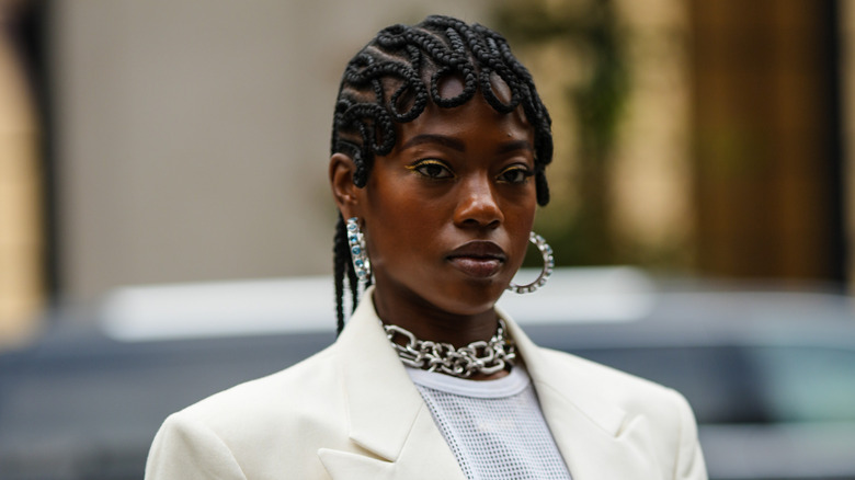 woman wearing blue gemstone hoop earrings