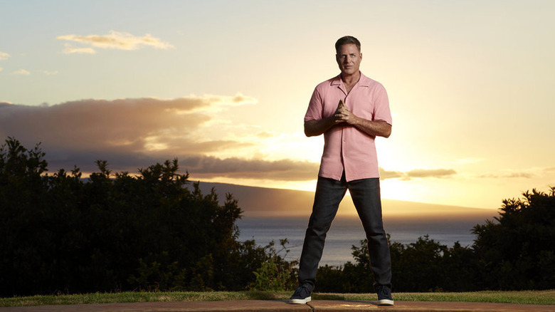 Mark L. Walberg posing in front of sunset