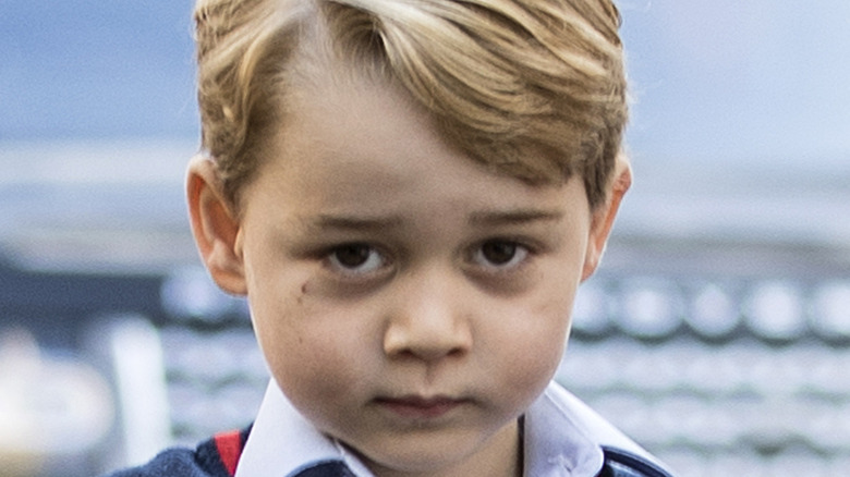 Prince George having his photo taken while in his school uniform