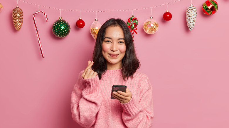 A woman standing in front of candy-themed garland