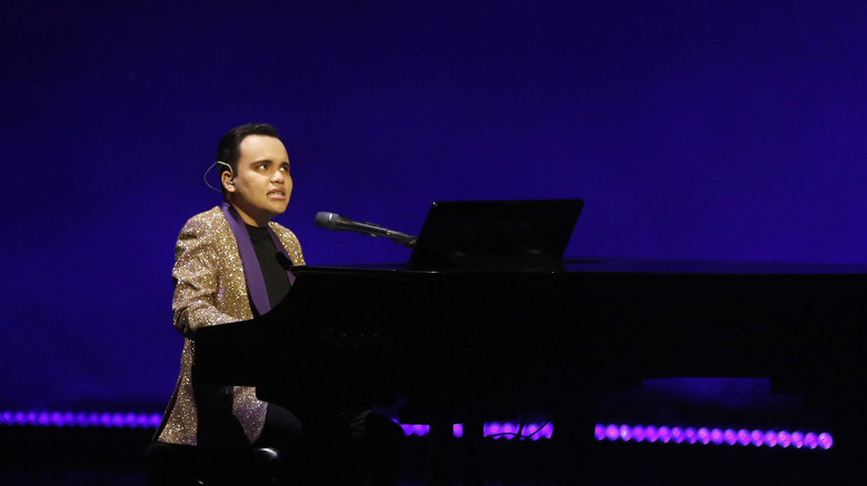 Kodi Lee performing onstage with a piano 
