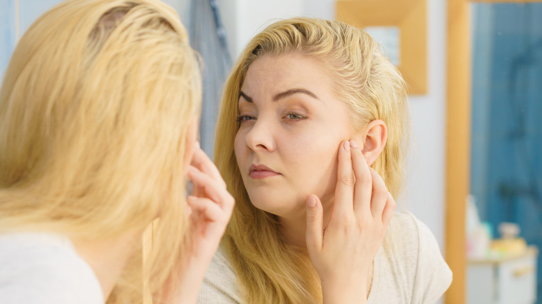 Woman checking for wrinkles