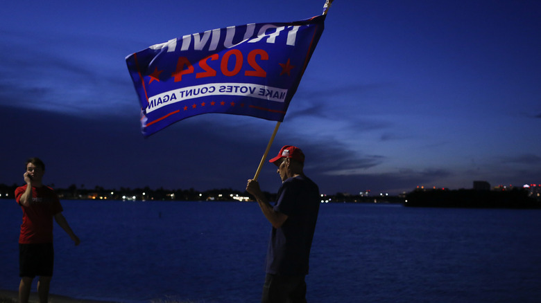 Someone holding flag near Mar-a-Lago