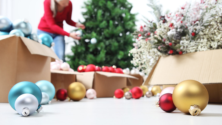 A person decorating a Christmas tree