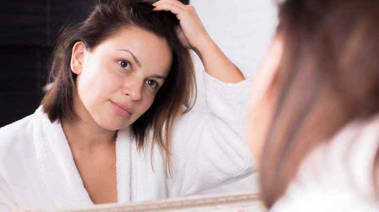 woman looking in mirror