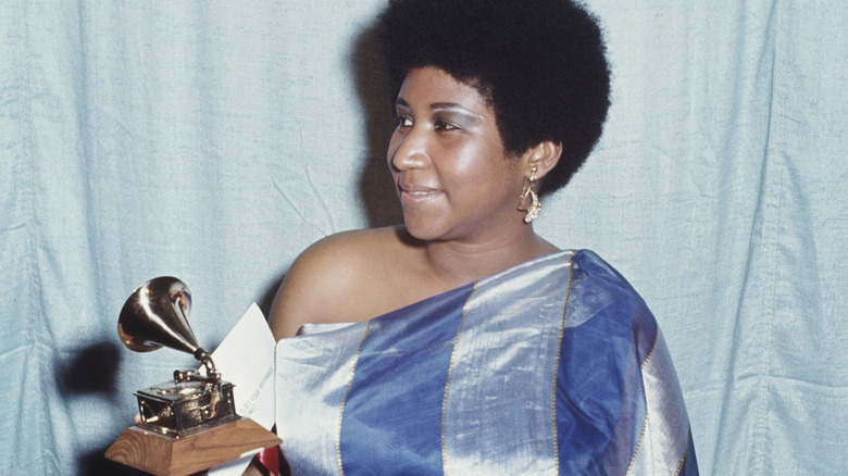 Aretha Franklin holding her Grammy