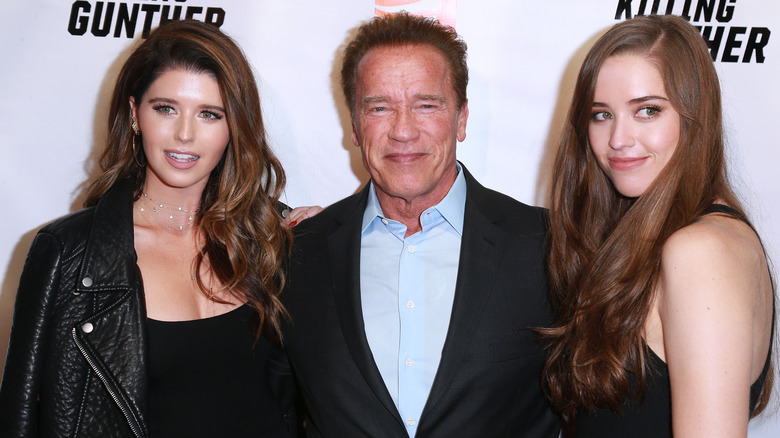 Katherine, Christina and Arnold Schwarzenegger posing with their father