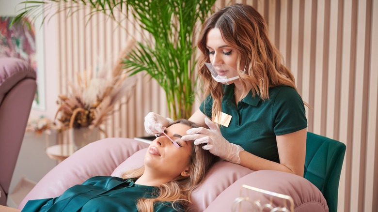 lash technician applying eyelash extensions