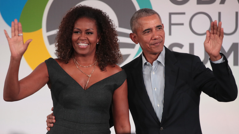 Barack and Michelle Obama wave to crowds