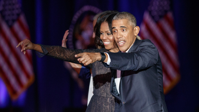  Barack Obama and Michelle pointing at a crowd