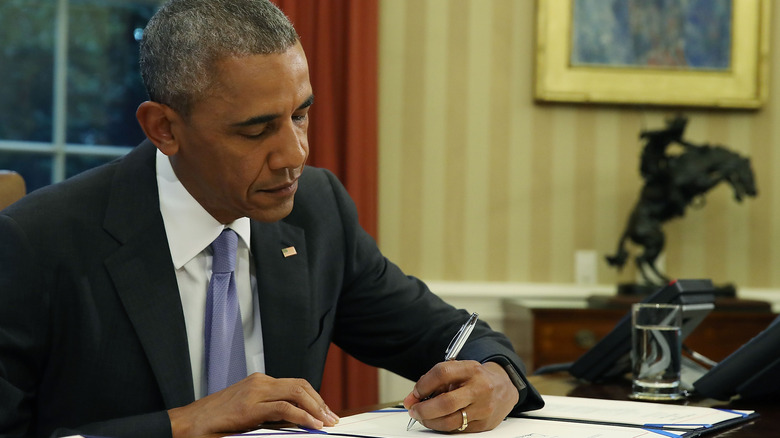 Barack Obama working in Oval Office