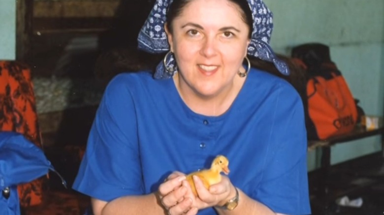 Stanley Ann Dunham smiles while holding a duck