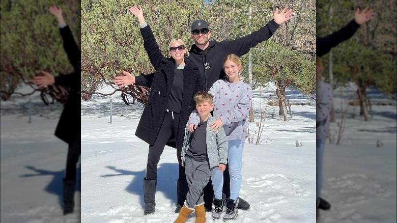 Heather Rae Young and Tarek El Moussa posing for a photo with his children