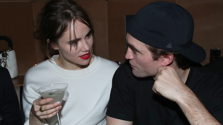 Suki Waterhouse holds martini and speaks to Robert Pattinson