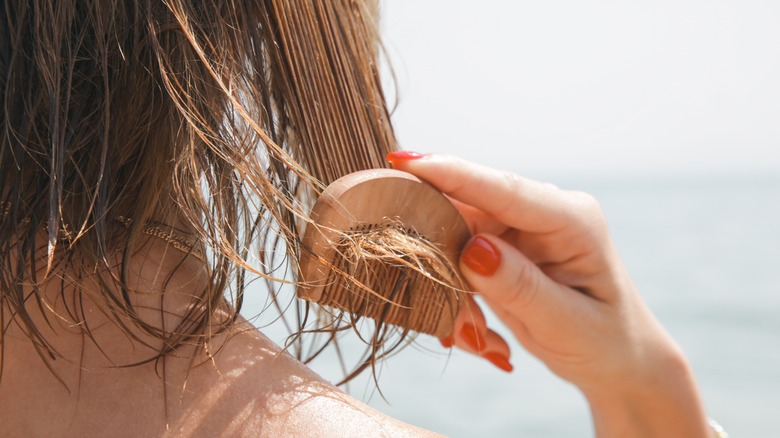 Woman combing hair