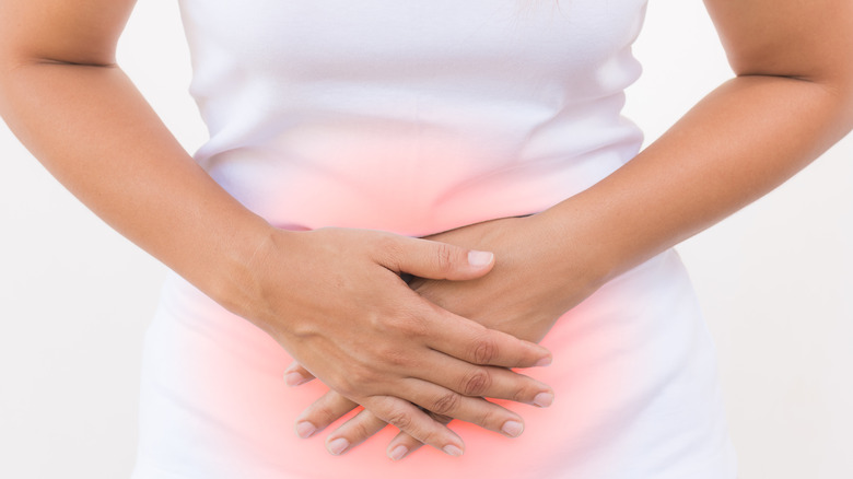 Woman holding abdomen