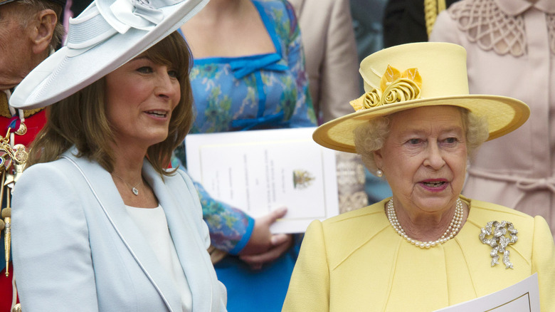 Carole Middleton and Queen Elizabeth II standing together