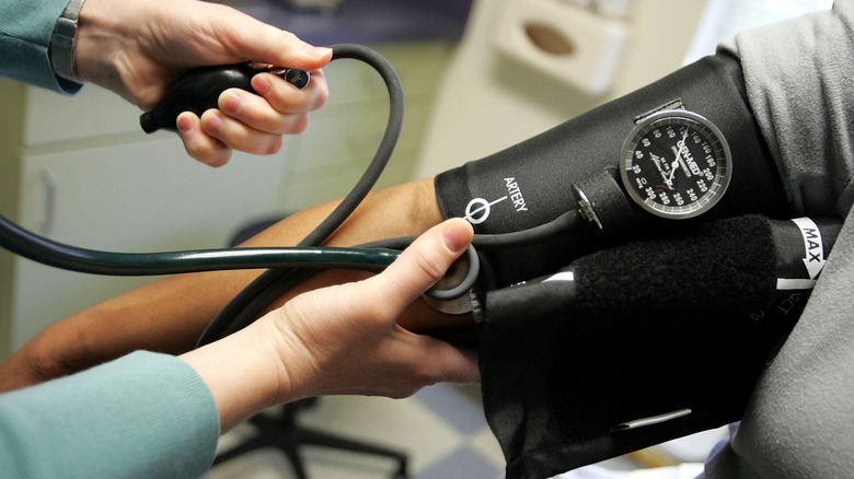 a doctor checking a patient's blood pressure