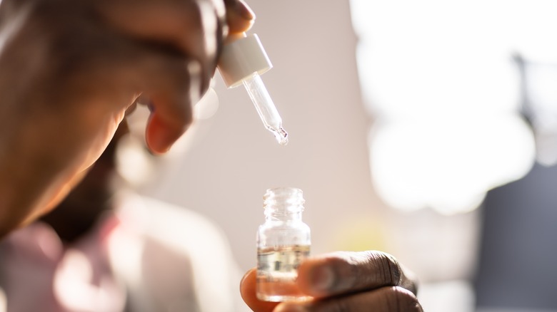 Man holding a bottle of CBD oil