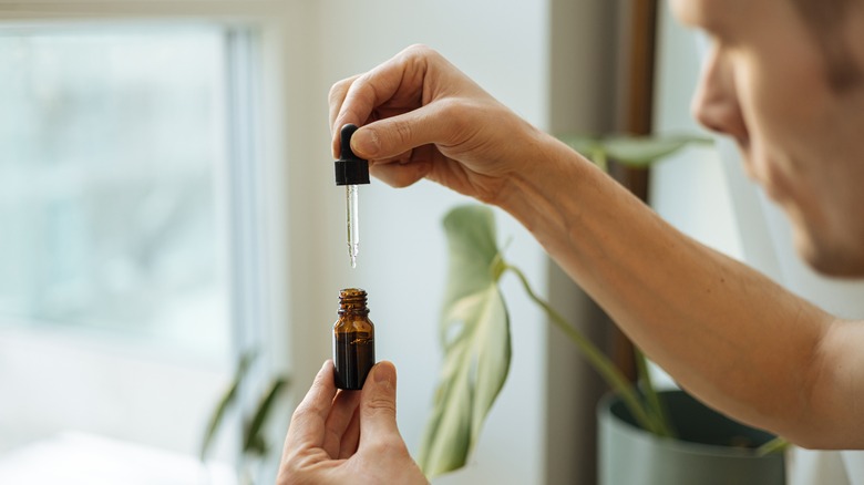 Man holding a bottle of CBD oil