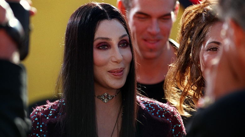 Cher listening to someone and smiling