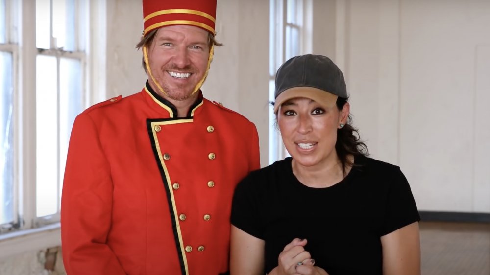 Chip Gaines, in a bellhop outfit with Joanna Gaines from Fixer Upper