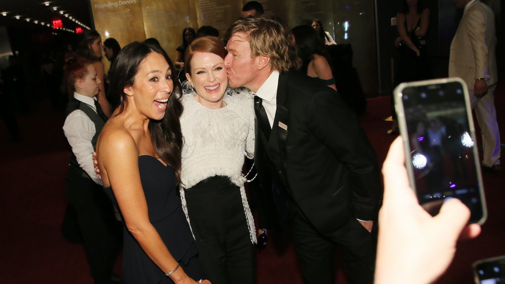 Fixer Upper's Chip Gaines and Joanna Gaines posing with a friend