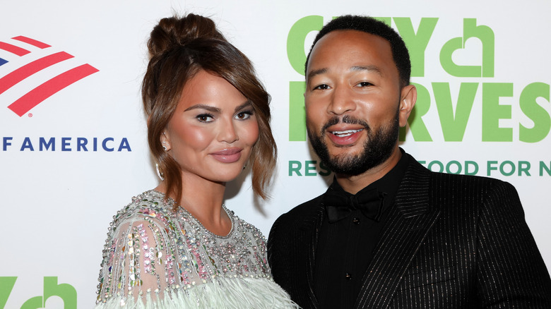 Chrissy Teigen and John Legend posing on the red carpet 