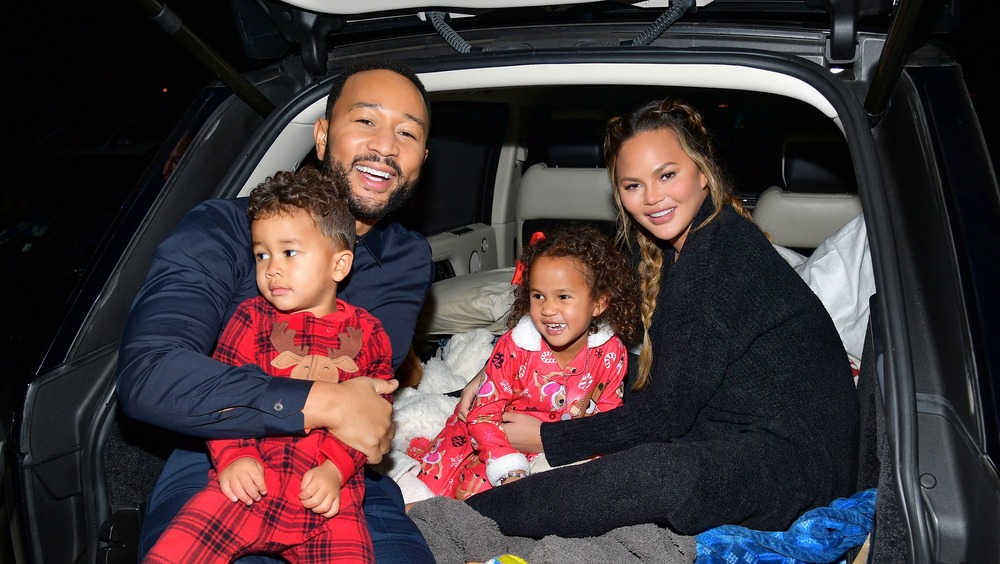 Chrissy Teigen, John Legend and their kids sitting in car