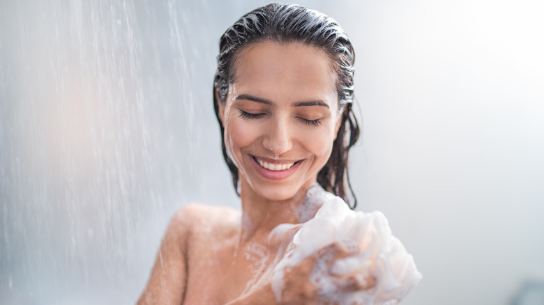 Woman smiling in cold shower